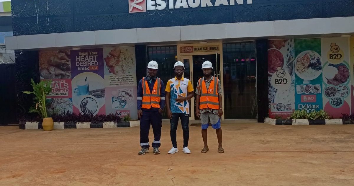 YST Energy team with a client at their business premises